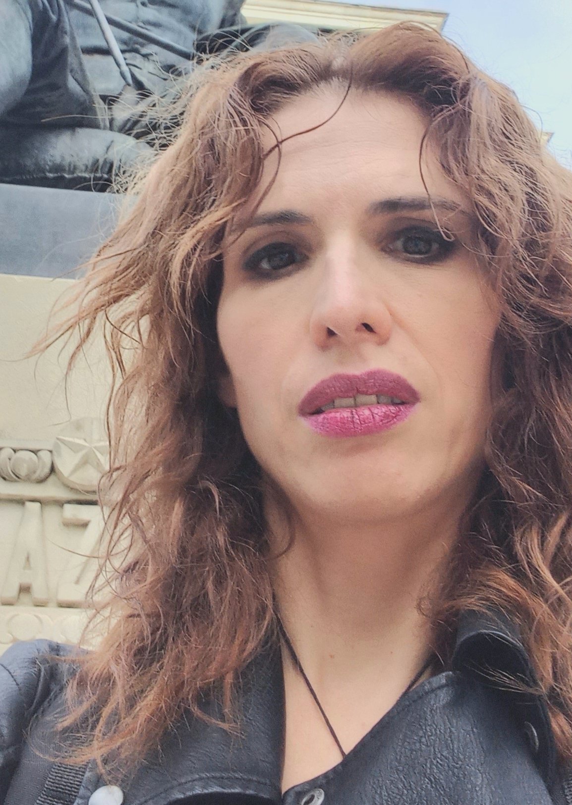 Porträttfoto av en kvinna med brunt lockigt hår.