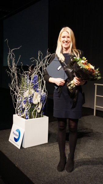 Sofia Björnfot Holmström at stage with flowers