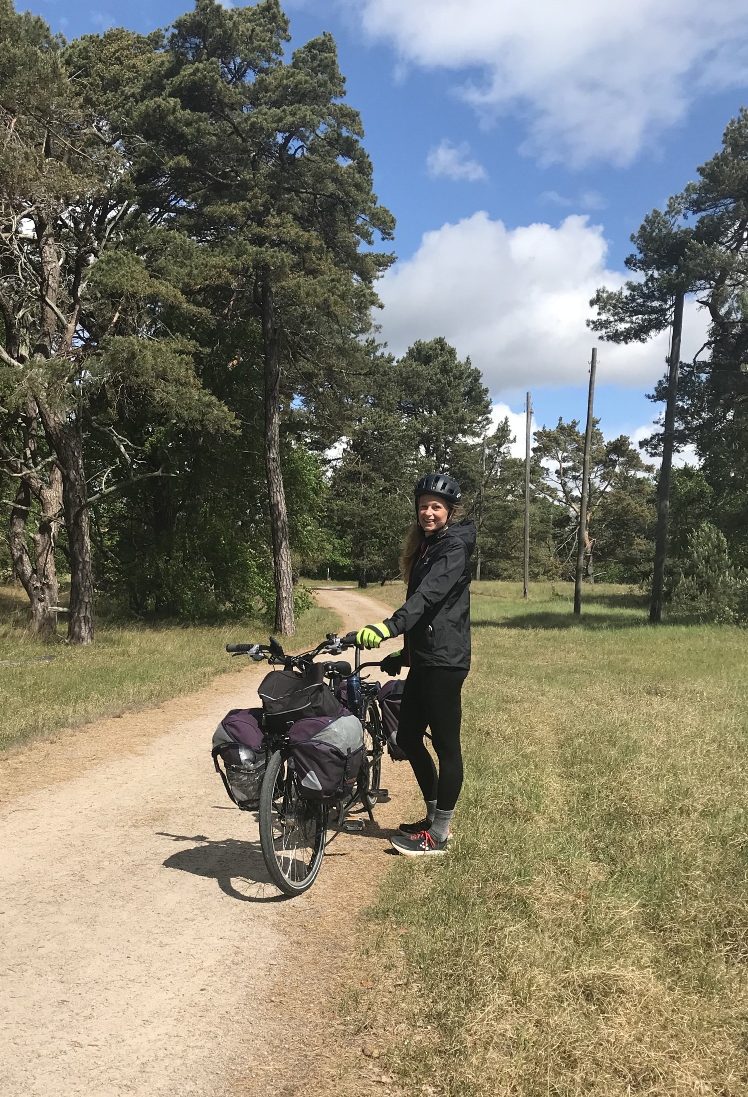 Pernilla Alencar Siljehag håller i tandemcykeln och står vid en grusväg.