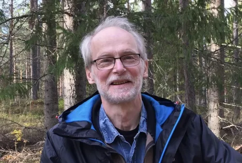 Portrait of Björn Vennström in the woods looking happy