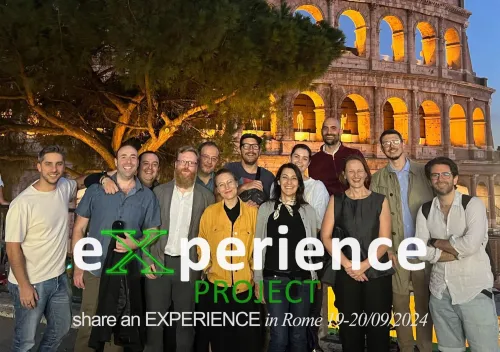 A group photo of the members in the EXPERIENCE team standing in from of the Colosseum, Rome.