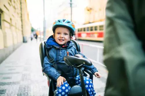 Smiling child with bicycle helmet.