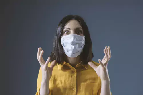 Worried woman with face mask.