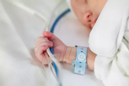 Newborn in hospital bed