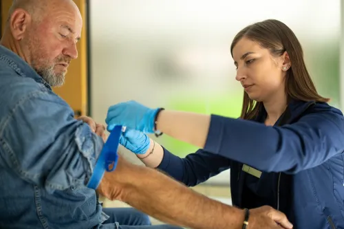 Stock photo, nurse taking a blood sample from a patient.
