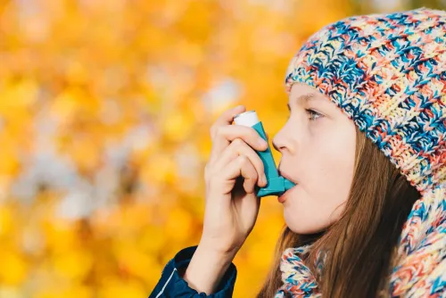 Girl with inhaler outdoors