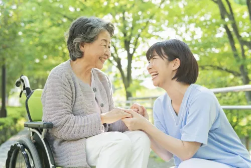 Senior woman in wheelchair and female health care worker
