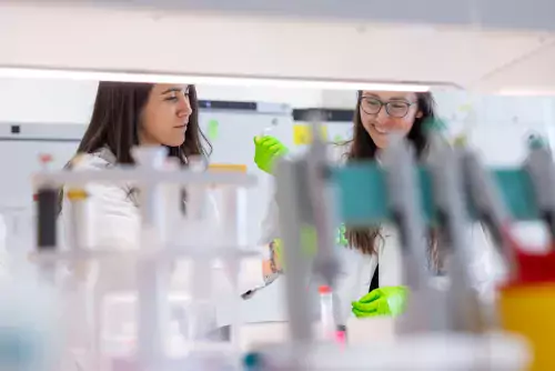 Two women working in lab environment.