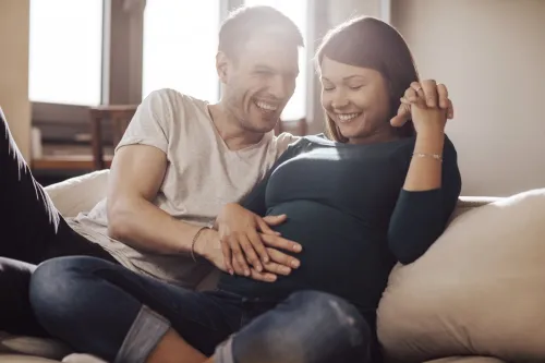 Pictur of a man and a pregnant woman.
