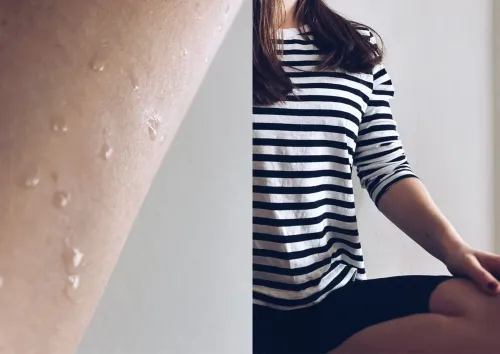 A collage with one close up picture of a sweaty arm and one picture of a person wearing a striped shirt and black pants sitting in a yoga position