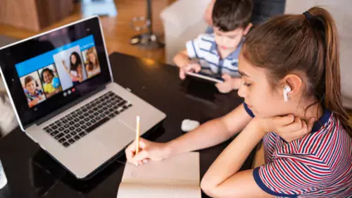 Children studying by using a computer at home.