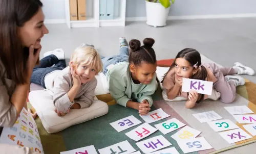 Children and teacher and letters.