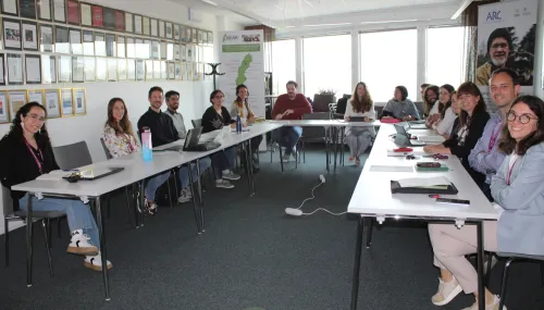 group picture of participants sitting at their tables.