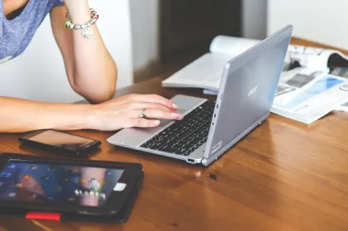 woman using laptop with mobile on the table