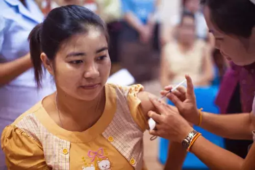 A woman receiving a vaccination.