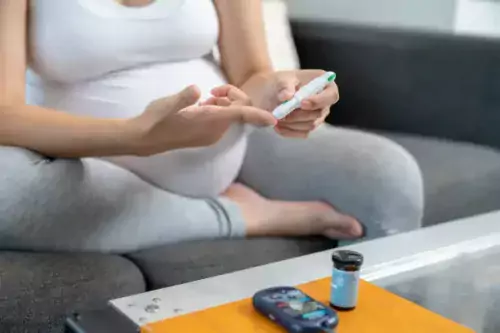 pregnant women taking a finger blood test