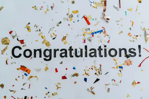 The text &quot;Congratulations!&quot; on a background of confetti.